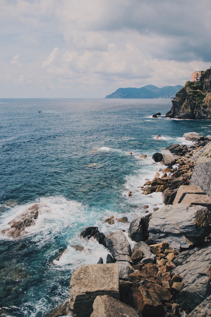 Photo by Jonas Thijs gray rocks beside body of water
